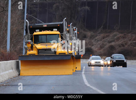 Snow plows wait on the side of interstate 495 in anticipation for a snow storm in Maryland on December 26, 2010. A severe winter storm is moving up the east coast of the United States. UPI/Kevin Dietsch Stock Photo