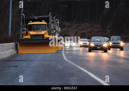 Snow plows wait on the side of interstate 495 in anticipation for a snow storm in Maryland on December 26, 2010. A severe winter storm is moving up the east coast of the United States. UPI/Kevin Dietsch Stock Photo