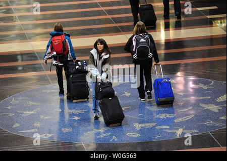Travelers walk through Washington National Airport as a winter storm has delayed or cancelled most of the flights for the region, December 26, 2010. A severe winter storm is moving up the east coast of the United States. UPI/Kevin Dietsch Stock Photo