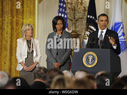 U.S. President Barack Obama makes remarks as he unveils a new initiative for military families, as First Lady Michelle Obama (C) and Dr. Jill Biden, wife of Vice President Joe Biden, also attend in the East Room of the White House, January 24, 2011 in Washington,D.C. Obama called for an effort to better coordinate and strengthen the Federal government's support for troops in the areas of education, housing, health care and quality of life issues.   UPI/Mike Theiler Stock Photo