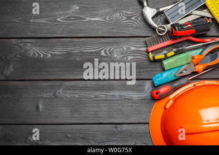 Assorted work tools on wooden table Stock Photo