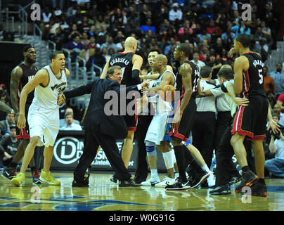 Washington Wizards' head coach Flip Saunders separates Washington Wizards' JaVale McGee (34) and Miami Heat's Juwan Howard (5) during the first half at the Verizon Center in Washington on March 30, 2011.  UPI/Kevin Dietsch Stock Photo