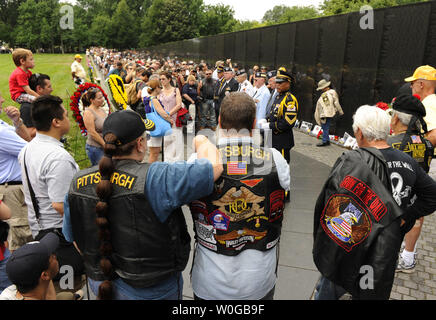 Bikers from Pittsburgh, PA, join tourists as they listen to an honor guard at the Vietnam War Memorial, during the Rolling Thunder Motorcycle Rally XXIV, on Memorial Day weekend, May 29, 2011, in Washington,D.C.  Hundreds of thousands of bikers annually converge on Washington for the rally to remember America's military veterans, POWs and MIAs.    UPI/Mike Theiler Stock Photo