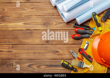 Assorted work tools on wooden table Stock Photo