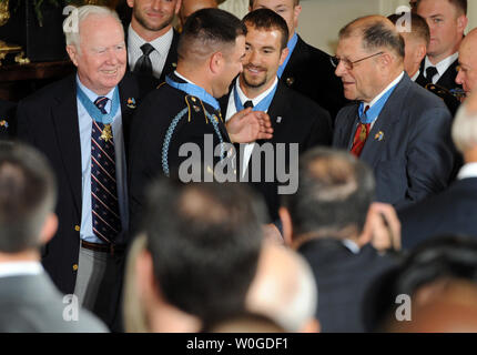 Sergeant First Class Leroy Arthur Petry, U.S. Army, shows President Barack  Obama a plaque with the names of the fallen Rangers from the 75th Regiment  on his prosthetic arm, during a meeting