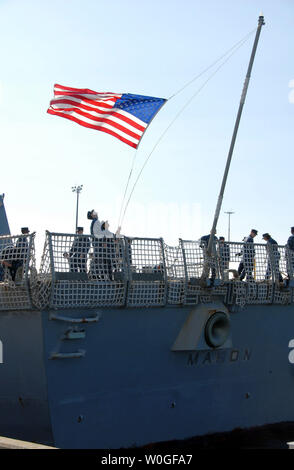 Sailors aboard the Arleigh Burke-class guided-missile destroyer USS Mason lower the flag as they depart Naval Station Norfolk, Virginia on August 25, 2011 ahead of Hurricane Irene. Vice Adm. Daniel Holloway, commander of U.S. 2nd Fleet, ordered all ships in the Hampton Roads area to set Sortie Condition Alpha. Ships in the area are departing the area early Thursday morning, Aug. 25. Irene's current track indicates it will pass off the North Carolina and Virginia coasts late Saturday as a Category 3 hurricane. UPI/ Rafael Martie/US Navy Stock Photo