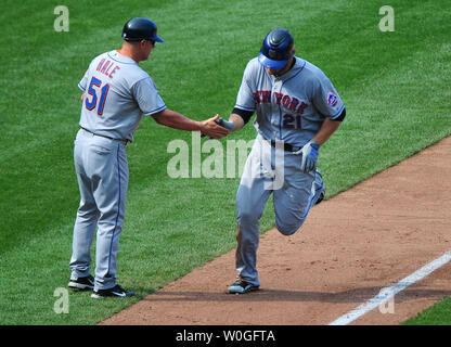 New York Mets' Lucas Duda shakes hands with third base coach Chip Hale after connecting for a solo homerun in the sixth inning against the Washington Nationals at Nationals Park in Washington on September 4, 2011.  UPI/Kevin Dietsch Stock Photo