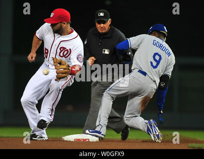 Los Angeles Dodgers' Dee Gordon holds on to his helmet as he