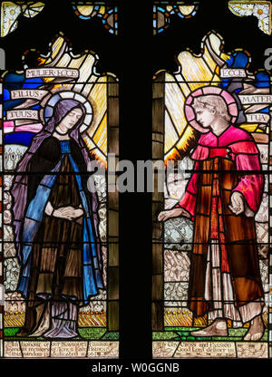 Christopher Whall's 1906 depiction of Mary and John hearing some of the final words of Jesus on the cross, St. Margaret's Church, Bagendon, UK Stock Photo