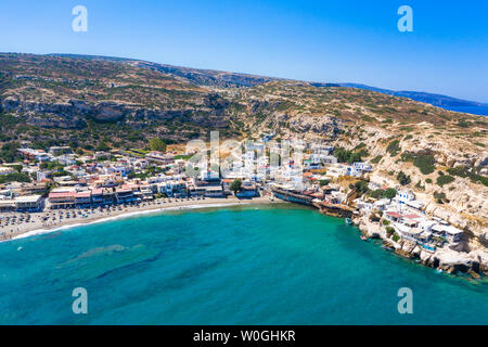 Matala beach with caves on the rocks that were used as a roman cemetery and at the decade of 70's were living hippies from all over the world, Crete, Stock Photo