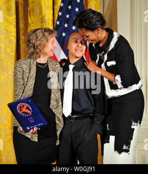 First Lady Michelle Obama gives a National Arts and Humanities Youth Program Award to members of ArtLab, from Denver Colorado, at the President's Committee on the Arts and Humanities National Arts and Humanities Youth Program Awards in the East Room of the White House in Washington on November 2, 2011.  UPI/Kevin Dietsch Stock Photo