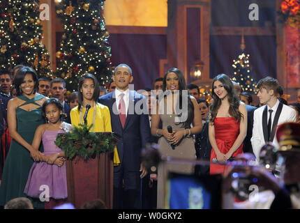 US President Barack Obama, first lady Michelle Obama and daughters Malia and Sasha are joined by entertainers (L-R) Jennifer Hudson, Victoria Justice and Justin Bieber for a final song at the conclusion of the performances at the annual 'Christmas in Washington' gala, December 11, 2011, Washington, DC.    UPI/Mike Theiler Stock Photo