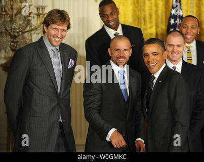 U.S. President Barack Obama shares a laugh with Dallas Mavericks players Dirk Nowitzki (L), of Germany, and Jason Kidd (C) while Mavericks head coach Rick Carlisle (R) looks on during a ceremony honoring the 2011 NBA Champions in the East Room of the White House on January 9, 2012 in Washington, DC.  Obama shared some laughs as he congratulated Dallas for their first National Basketball League Championship.    UPI/Pat Benic Stock Photo