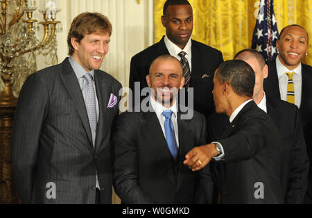 U.S. President Barack Obama shares a laugh with Dallas Mavericks players Dirk Nowitzki (L), of Germany, and Jason Kidd (C) during a ceremony honoring the 2011 NBA Champions in the East Room of the White House on January 9, 2012 in Washington, DC.  Obama shared some laughs as he congratulated Dallas for their first National Basketball League Championship.    UPI/Pat Benic Stock Photo