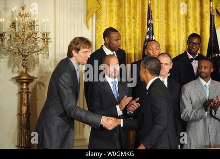 U.S. President Barack Obama shakes hands with Dallas Mavericks center Dirk Nowitzki (L), of Germany, and Jason Kidd (C) during a ceremony honoring the 2011 NBA Champions in the East Room of the White House on January 9, 2012 in Washington, DC.  Obama shared some laughs as he congratulated Dallas for their first National Basketball League Championship.    UPI/Pat Benic Stock Photo