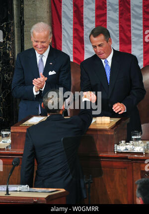President Barack Obama greets Speaker of the House John Boehner (R-OH) as Vice President Joe Biden watches on prior to delivering his State of the Union address to a joint session of Congress in the U.S. Capitol Building in Washington, D.C. on January 24, 2012.  UPI/Kevin Dietsch Stock Photo