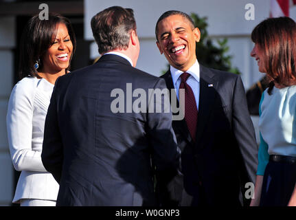 U.S. President Barack Obama and First Lady Michelle Obama share a laugh as they welcome Prime Minister of the United Kingdom David Cameron and his wife Samantha during and official arrival ceremony on the South Lawn of the White House in Washington, D.C. on March 14, 2012.  UPI/Kevin Dietsch Stock Photo