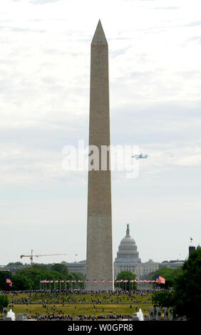 The Space Shuttle Discovery atop the NASA Shuttle Carrier Aircraft, a modified Bowing 747, flies past the Washington Monument and the United States Capitol on its way to the Smithsonian National Air and Space Museum Virginia annex for its permanent display on April 17, 2012 in Washington, DC.  The shuttle flew over the Nation's Capital at 1500 feet offering a great view for residents and tourists before landing at Dulles International Airport.   UPI/Pat Benic Stock Photo