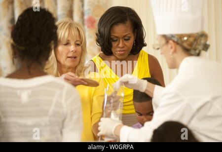 First Lady Michelle Obama and Dr. Jill Biden, wife of Vice President Joe Biden, work on craft projects with children from military families during a luncheon for military families for Mother Day at the White House in Washington on May 10, 2012.    UPI/Kevin Dietsch Stock Photo