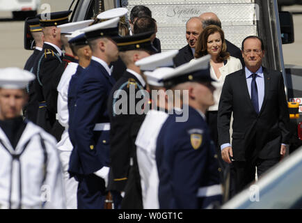 Newly-elected French President Francois Hollande (R) walks past an honor guard with his companion Valerie Trierweiler as his delegation arrives at Dulles International Airport, Chantilly, Virginia, May 18, 2012 for the weekend G-8 and NATO Summits. The Group of 8 will be meeting with President Obama's administration officials at Camp David, Maryland and the NATO Summit will be in Chicago, Illinois.    . (UPI Photo/Mike Theiler) Stock Photo