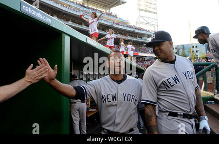 New York Yankees Alex Rodriguez shakes hands with teammates in the dugout with Andruw jones (R) as they get ready to play the Washington Nationals  at Nationals Park in Washington, DC on June 15, 2012.    UPI/Pat Benic Stock Photo