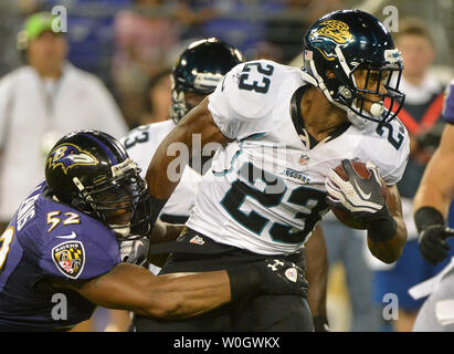 Jacksonville Jaguars running back Rashad Jennings (23) wards off New York  Giants linebacker Clint Sintim (52) on a long run into the red zone during  first half week 12 NFL action between