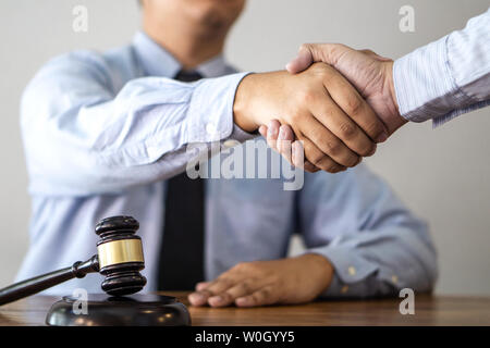 Handshake after consultation between a male lawyer and client, giving advice and prosecutions about the regarding real estate. Stock Photo