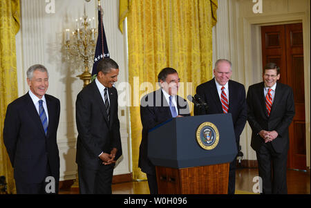 Defense Secretary Leon Panetta (C) makes a joke as he is joined by, from left to right, Defense Secretary nominee former Sen. Chuck Hagel (R-ND)  President Barack Obama, CIA Director nominee John Brennan and CIA acting director Michael Morell,  during a nomination ceremony in the East Room at the White House in Washington, DC on January 7, 2012. UPI/Kevin Dietsch Stock Photo