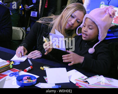 Chelsea Clinton, daughter of former US President Bill Clinton (L) joins Addison Rose, 8, of Washington, DC, in making greeting cards for hospitalized kids, as they participate in the National Day of Service, in Washington, DC, January 19, 2013. The National Day of Service, begun by President Barack Obama and the first family, is a legacy of the Rev. Martin Luther King, Jr,. whose holiday on January 21, will coincide with the 57th Inauguration.  .       UPI/Mike Theiler Stock Photo