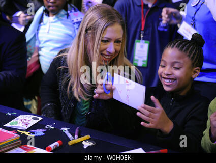 Chelsea Clinton, daughter of former US President Bill Clinton (L) joins Addison Rose, 8, of Washington, DC, in making greeting cards for hospitalized kids, as they participate in the National Day of Service, in Washington, DC, January 19, 2013. The National Day of Service, begun by President Barack Obama and the first family, is a legacy of the Rev. Martin Luther King, Jr,. whose holiday on January 21, will coincide with the 57th Inauguration.  .       UPI/Mike Theiler Stock Photo