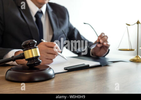 Law, lawyer attorney and justice concept, male lawyer or notary working on a documents and report of the important case in the law firm. Stock Photo