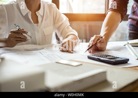 Team of Construction engineering or architect hands working on blueprint inspection in workplace, drawing and sketching meeting for architectural proj Stock Photo