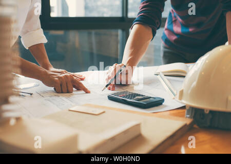 Image of engineer or architect partner meeting for working with architectural project, drawing and sketching for inspection architectural project on b Stock Photo
