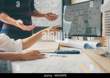 Image of engineer or architect partner meeting for working with architectural project, drawing and sketching for inspection architectural project on b Stock Photo