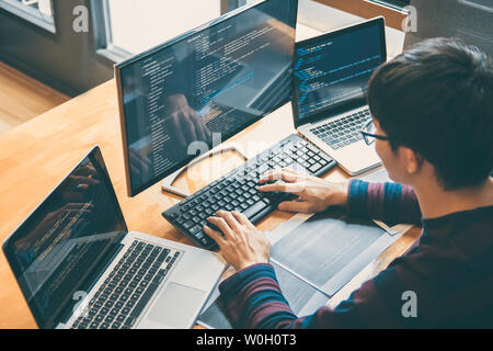 Professional Development programmer working in programming website a software and coding technology, writing codes and data code, Programming with HTM Stock Photo