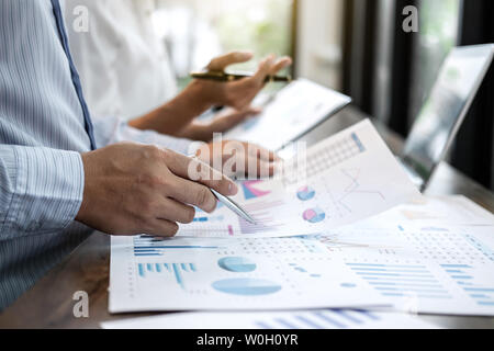 Businessman accountant and secretary making working audit and calculating expense financial annual financial report balance sheet statement, doing fin Stock Photo