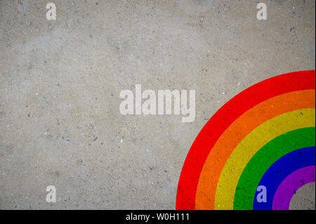 Brightly colored gay pride rainbow corner on wall of smooth gray concrete copy space Stock Photo