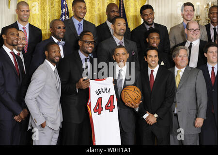 US President Barack Obama holds an autographed basketball as he poses for a group photo along with LeBron James (holding Obama jersey)as Dwayne Wade holds a, as the National Basketball Association (NBA) 2012 Champion  Miami Heat visit the White House, January 28, 2013, in Washington, DC.    UPI/Mike Theiler Stock Photo