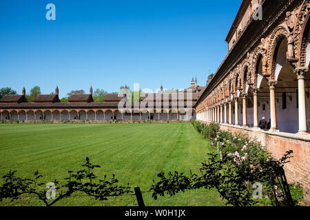 CERTOSA DI PAVIA, ITALY - APRIL 30, 2019: Tourists visit the Grand Cloister of Certosa di Pavia monastery. Lombardy, Italy Stock Photo