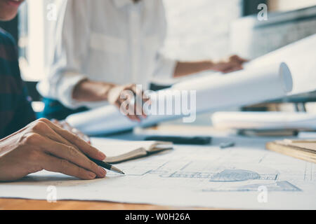 Team of Construction engineering or architect hands working on blueprint inspection in workplace, drawing and sketching meeting for architectural proj Stock Photo