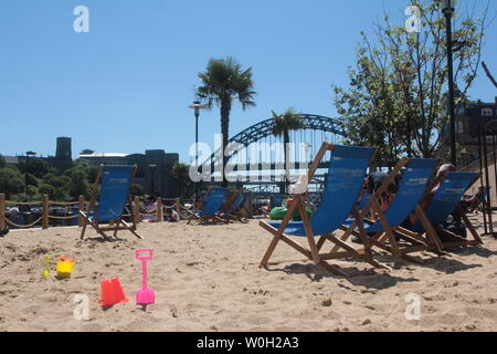 Newcastle upon Tyne, UK, 27th June, 2019, People enjoy pop-up beach on Newcastle's Quayside as Met Office confirm heatwave across the UK and Europe in the coming days, Credit: DavidWhinham/Alamy Live News Stock Photo