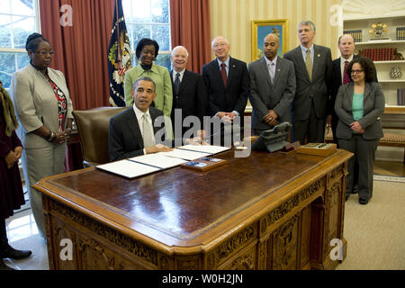 President Barack Obama delivers remarks prior to signing a bill designating Charles Young Buffalo Soldiers, in Ohio, a National Monument during a bill signing ceremony in the Oval Office at the White House on March 25, 2013 in Washington, D.C. President Obama signed a series of bills designating five new National Monuments, including, Rio Grande del Norte, in New Mexico, the First State National Monument in Delaware, the Harriet Tubman Underground Railroad National Monument in Maryland, the Charles Young Buffalo Soldiers Naitonal Monument in Ohio and the San Juan Islands National Memorial in W Stock Photo