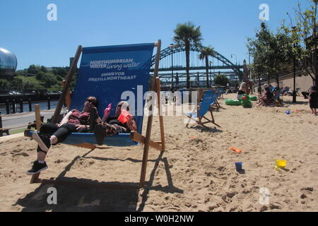 Newcastle upon Tyne, UK, 27th June, 2019, People enjoy pop-up beach on Newcastle's Quayside as Met Office confirm heatwave across the UK and Europe in the coming days, Credit: DavidWhinham/Alamy Live News Stock Photo