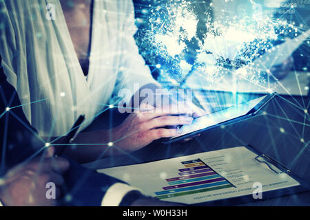 Businessperson in office connected on internet network with tablet. concept of partnership and teamwork Stock Photo