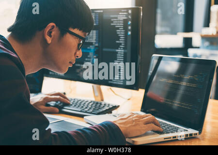 Professional Development programmer working in programming website a software and coding technology, writing codes and data code, Programming with HTM Stock Photo
