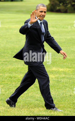 US President Barack Obama waves to the press as he returns to the White House, May 24, 2013, Washington, DC after a day trip to Annapolis, Maryland where he attended commencement exercises at the US Naval Academy.          UPI/Mike Theiler Stock Photo