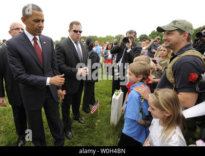 US President Barack Obama gives a thumbs up while visiting with families at Arlington National Cemetery on Memorial Day, in Arlington, Virginia, May 27, 2013. On Memorial Day the nation honors its military veterans and those who have died in the country's conflicts.      UPI/Mike Theiler Stock Photo