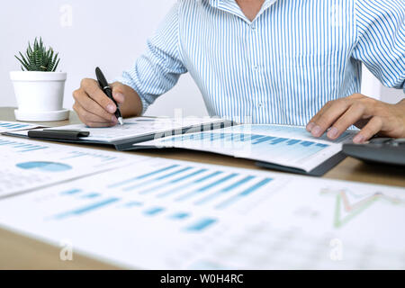 Businessman accountant making working audit and calculating expense financial annual financial report balance sheet statement, doing finance making no Stock Photo