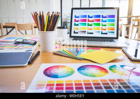 Graphic designer object tool and color swatch samples at workspace. Stock Photo