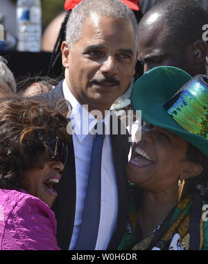 US Attorney General Eric Holder (C) poses with two guests,as he arrives to mark the 50th anniversary of  Dr Martin Luther King's, ' I Have a Dream ' speech, August 24, 2013, in Washington, DC. Civil rights leaders and politicians joined thousands to remember the 1963 March on Washington.        UPI/Mike Theiler Stock Photo